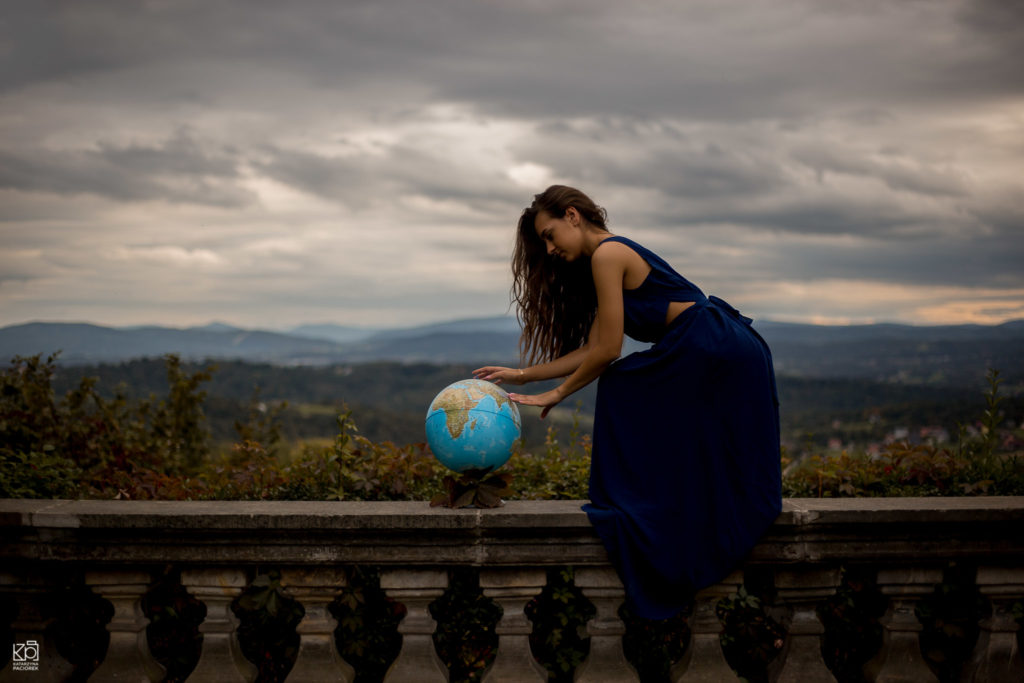 Kobieta pochylająca się nad globusem